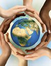 Photo of hands holding earth
