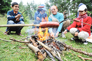 people sitting around campfire