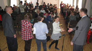photo of a student receiving an award during the spelling bee at Donetsk University