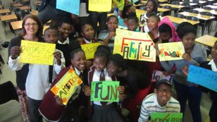 Photo of Access participants and teacher holding signs