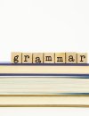 Letter tiles spell "Grammar" on top of a stack of books