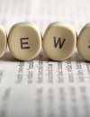 Blocks sitting on newsprint that spell out "NEWS"