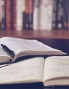 Open textbooks with pen